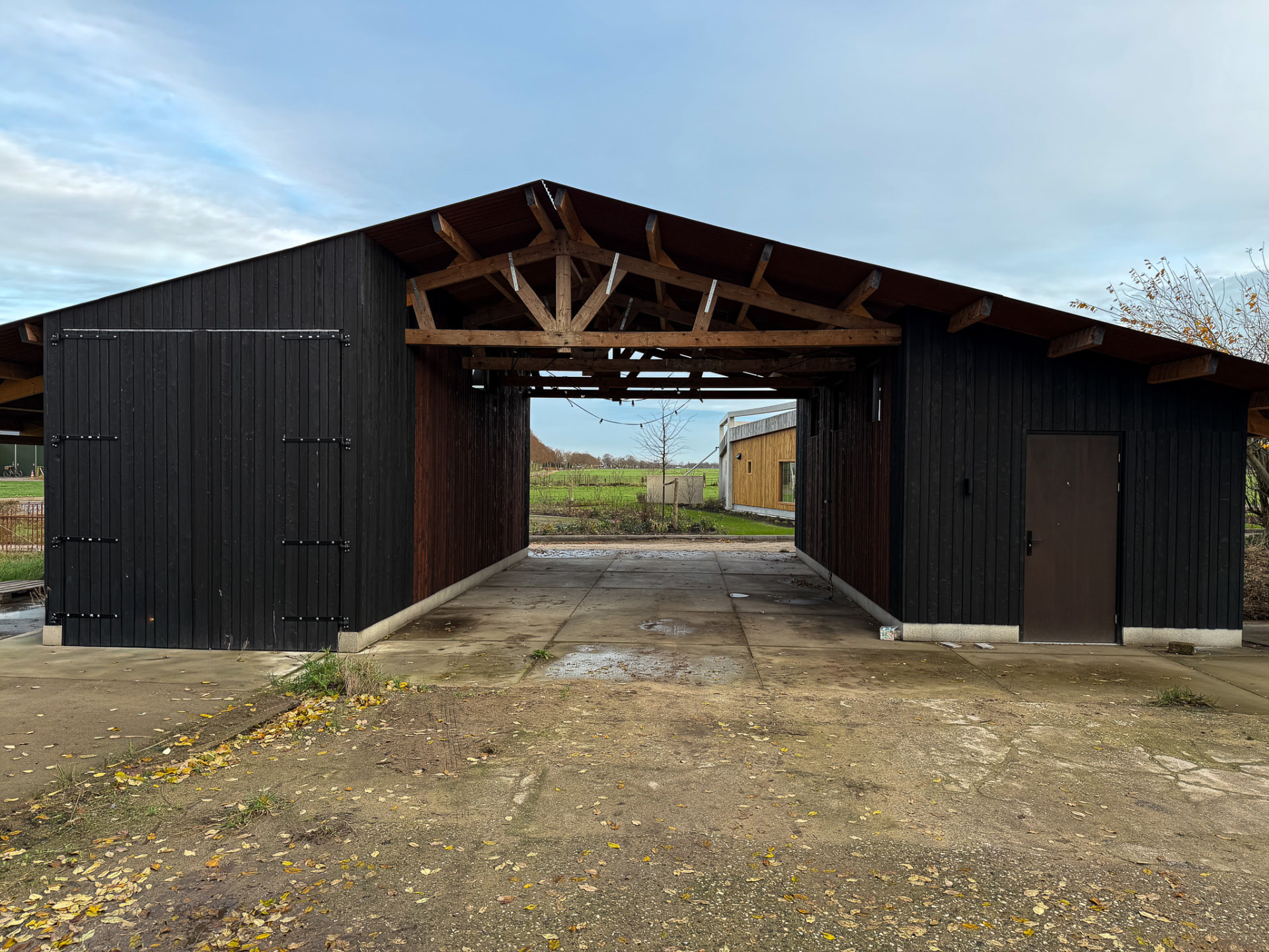 Open charred larch barn in Enschede used for parking and family gatherings