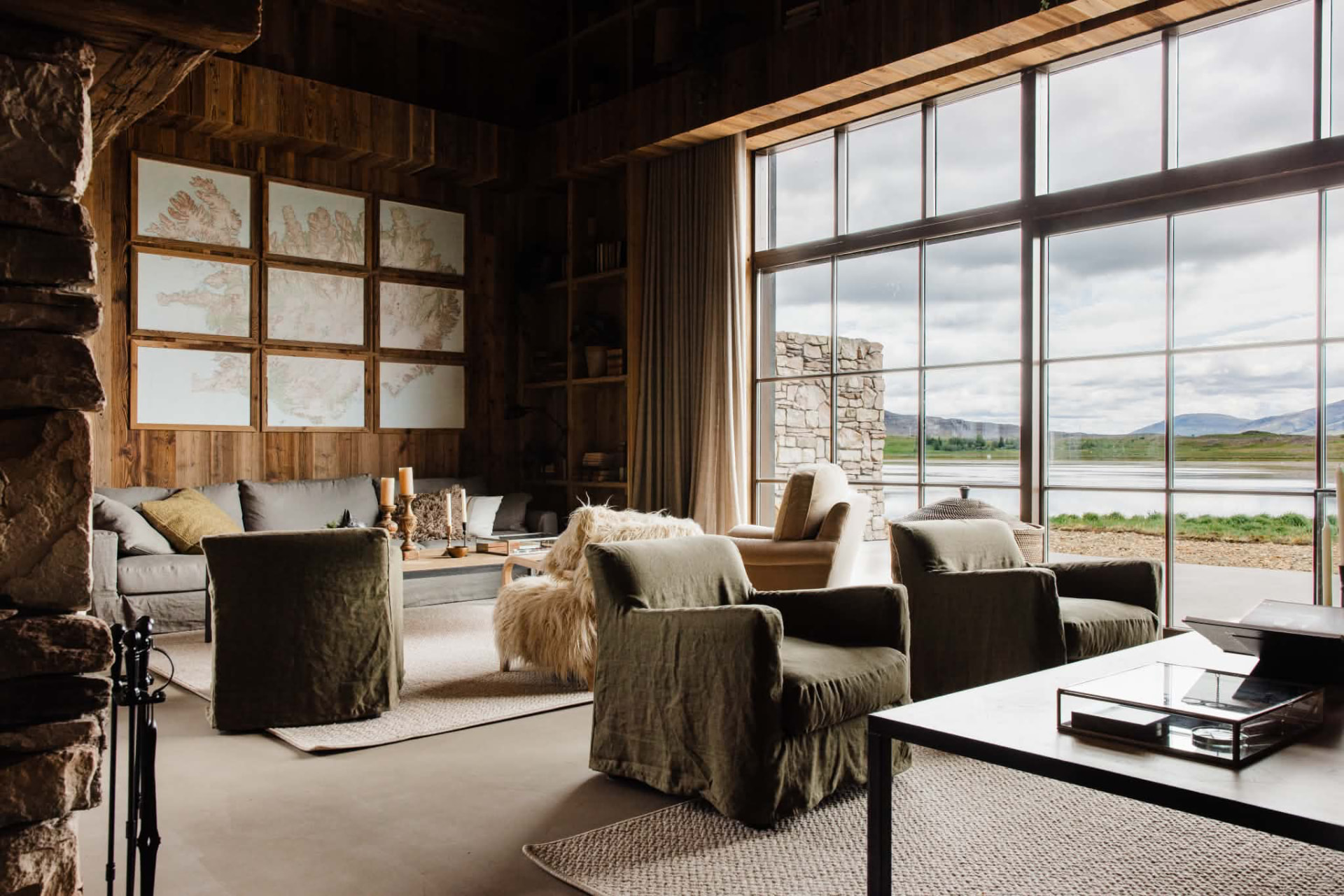 Lakeside lounge in Iceland lined in brushed reclaimed timber with full-height glazing