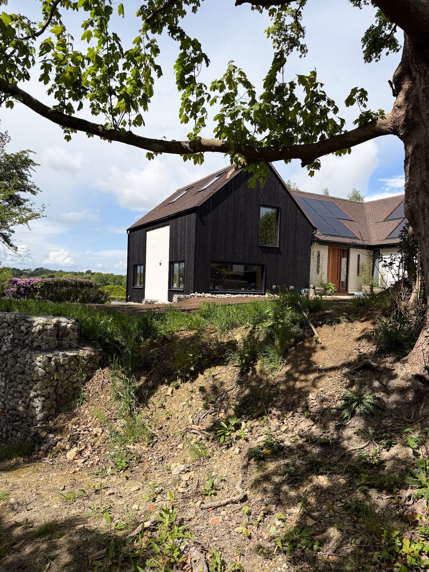 Gabled house extension in East Sussex clad in vertical KAEN Carbon charred larch